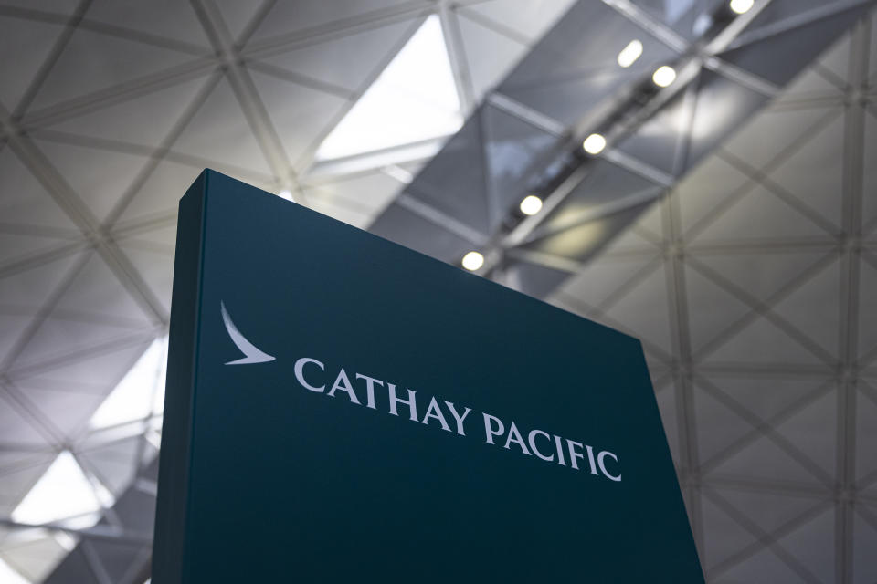 A signage for Cathay Pacific Airways at the departures hall of Hong Kong International Airport in Hong Kong, on Wednesday, March. 8, 2023. Cathay Pacific Airways Ltd. said it was ready to rebuild as Hong Kong opened up to global visitors, despite reporting wider losses in 2022. (AP Photo/Louise Delmotte)