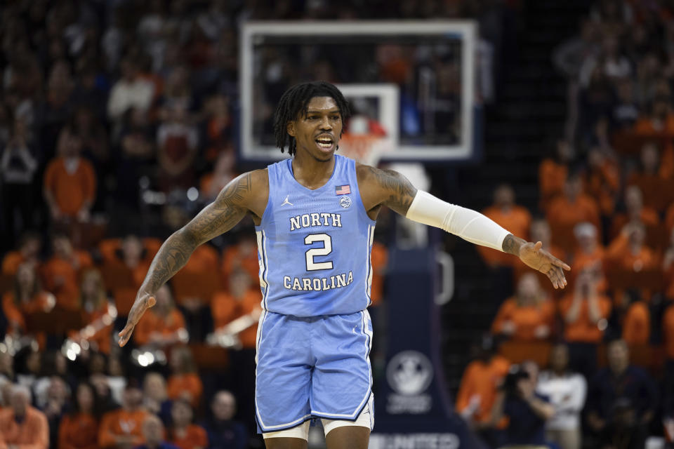 North Carolina's Caleb Love (2) celebrates during the first half of an NCAA college basketball game against Virginia in Charlottesville, Va., Tuesday, Jan. 10, 2023. (AP Photo/Mike Kropf)