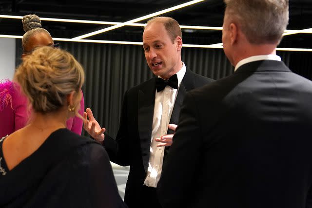 <p>Arthur Edwards - WPA Pool/Getty</p> Prince William talks with staffers at the Diana Award on March 14.