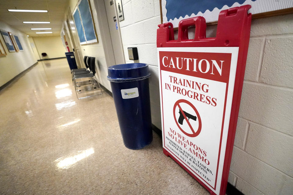 In this Sept. 9, 2020, photo a sign is seen in the hallway near classrooms where Baltimore Police Academy cadets attend classes in Baltimore. (AP Photo/Julio Cortez)