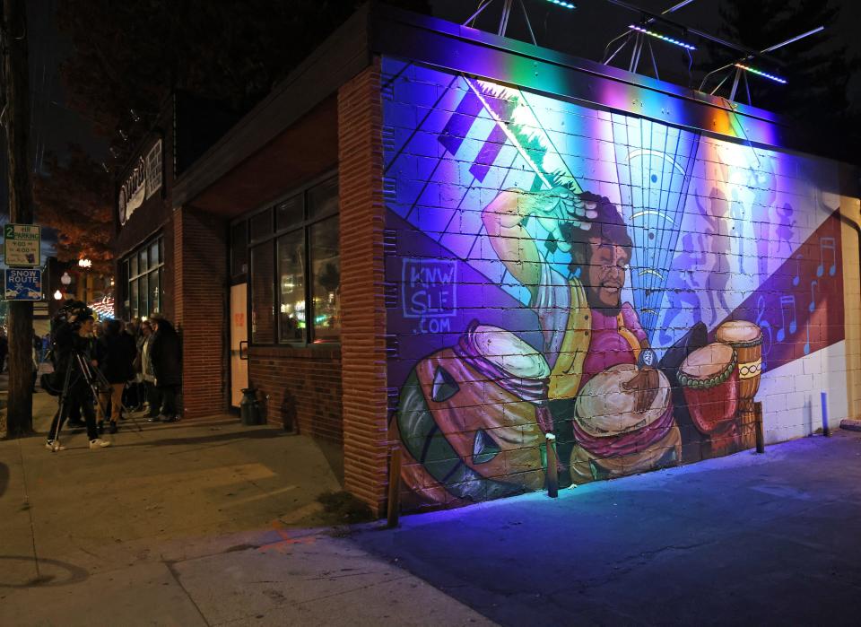 A beautiful mural decorates the exterior of Lefty's Live Music, 2307 University Ave., during the reveal of this season's Dogtown Lights in the Drake neighborhood, featuring dining, shopping and entertainment in Des Moines on Saturday, Nov. 11, 2023.