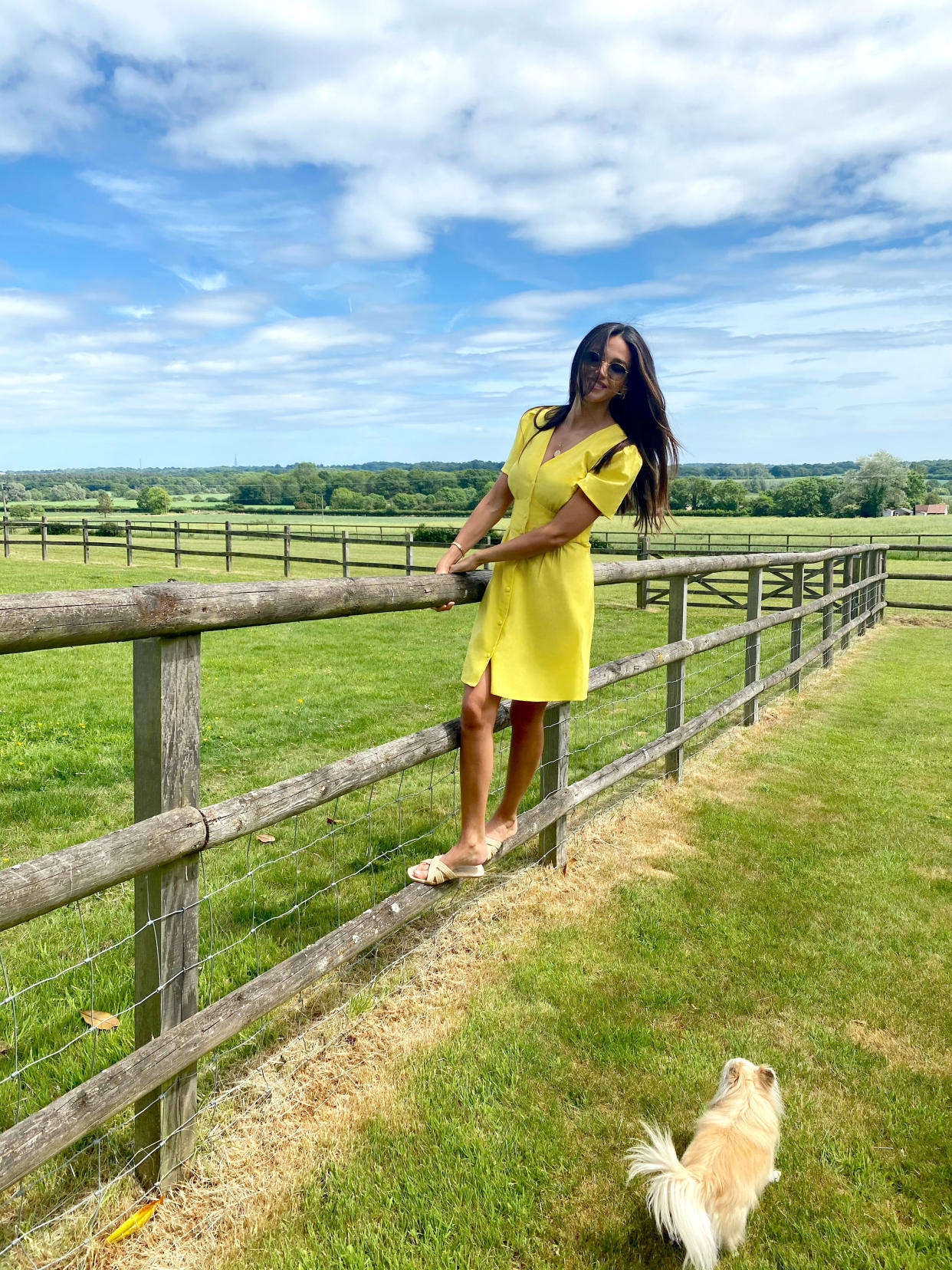 Michelle Keegan plays around in the garden, and swings from a fence, in a vibrant yellow sundress from her new drop.  (Very)