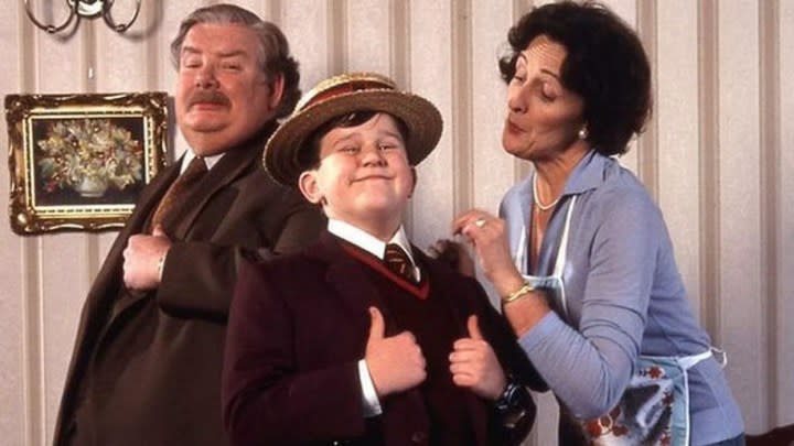 The Dursleys pose for a family portrait. 