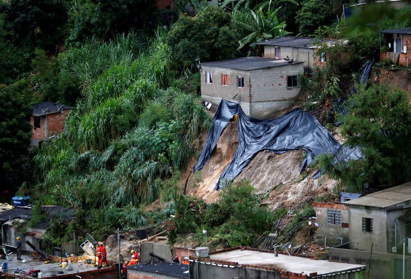 FILE PHOTO: Rescue workers search the site of a mudslide, after heavy rains at Vila Ideal neighborhood in Belo Horizonte