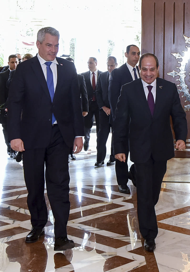 In this photo provided by Egypt's presidency media office, Egyptian President Abdel-Fattah el-Sissi, right, walks next to Austrian Federal Chancellor Karl Nehammer, left, at the Presidential Palace in Cairo, Egypt, Sunday, March 17, 2024. (Egyptian Presidency Media Office via AP)