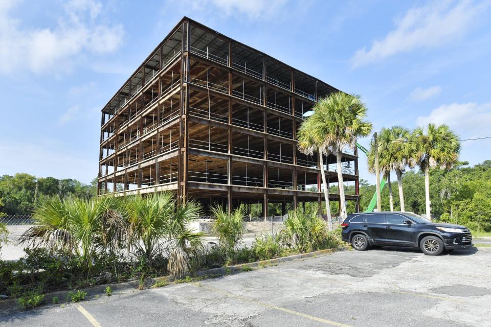 The abandoned office building off the Arlington Expressway that used to house the FBI Building is being gutted after years of sitting derelict Tuesday morning, August 1, 2023. [Bob Self/Florida Times-Union]