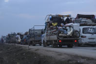 Truckloads of civilians flee a Syrian military offensive in Idlib province on the main road near Hazano, Syria, Tuesday, Dec. 24, 2019. Syrian forces launched a wide ground offensive last week into the northwestern province of Idlib, which is dominated by al-Qaida-linked militants. The United Nations estimates that some 60,000 people have fled from the area, heading south, after the bombings intensified earlier this month. (AP Photo/Ghaith al-Sayed)