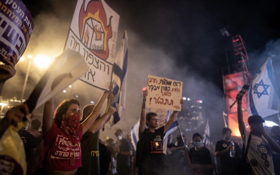 Thousands holding banners gather during a demonstration to demand a hostage swap deal