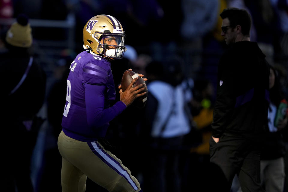 FILE - Washington quarterback Michael Penix Jr. (9) warms up before an NCAA college football game against Washington State, Saturday, Nov. 25, 2023, in Seattle. Penix is a finalists for the Heisman Trophy. (AP Photo/Lindsey Wasson, File)