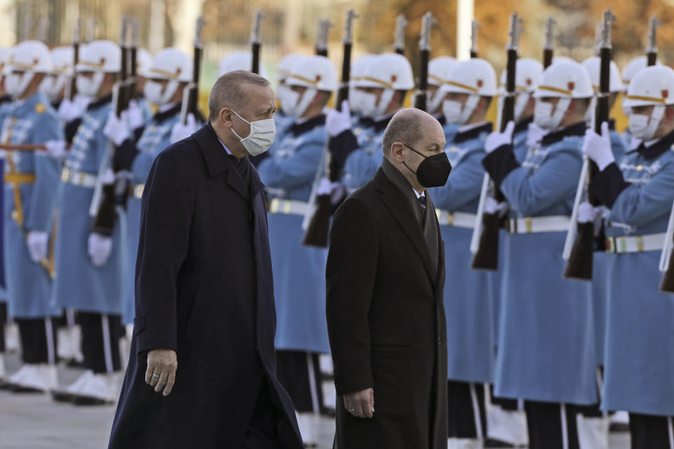 Turkish President Recep Tayyip Erdogan, left, and Germany's Chancellor Olaf Scholz review a military honour guard during a ceremony in Ankara, Turkey, Monday, March 14, 2022. Scholz is visiting Turkey Monday in his first official trip to the country since he took office in December. He will hold talks with Turkish President Recep Tayyip Erdogan in Ankara.(AP Photo/Burhan Ozbilici)