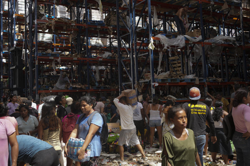 People take items from stores in the aftermath of Hurricane Otis, in Acapulco, Mexico, Saturday, Oct. 28, 2023. (AP Photo/Felix Marquez)