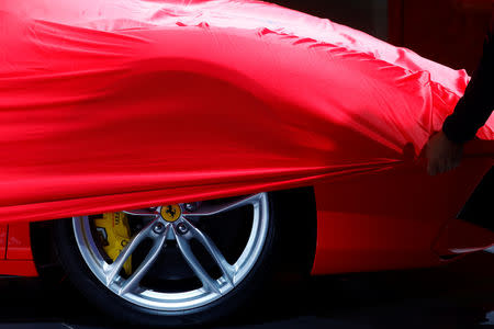 FILE PHOTO: A partially covered Ferrari car is pictured before the opening of the Frankfurt Motor Show (IAA) in Frankfurt, Germany, September 11, 2017. REUTERS/Kai Pfaffenbach/File Photo