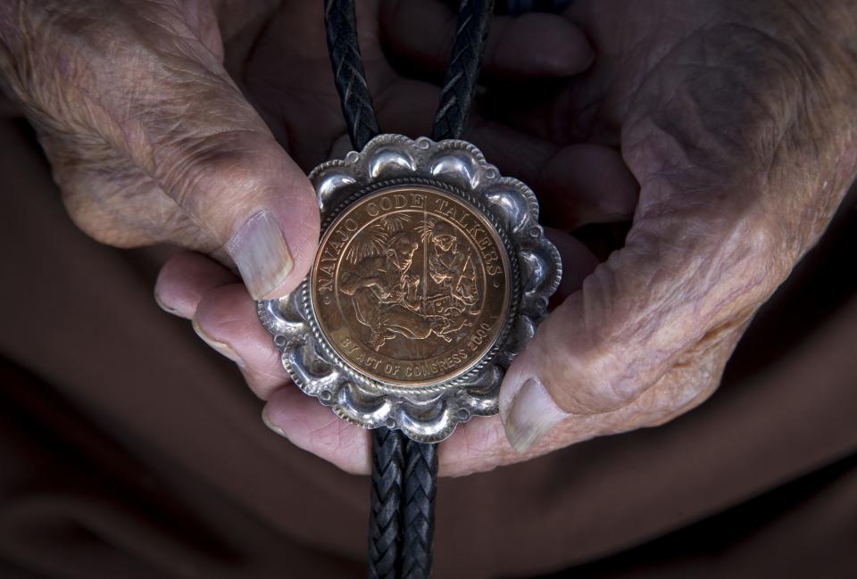 Navajo Code Talker Samuel Sandoval holds a replica of his Congressional Silver Medal on July 7, 2019, in Shiprock, New Mexico.