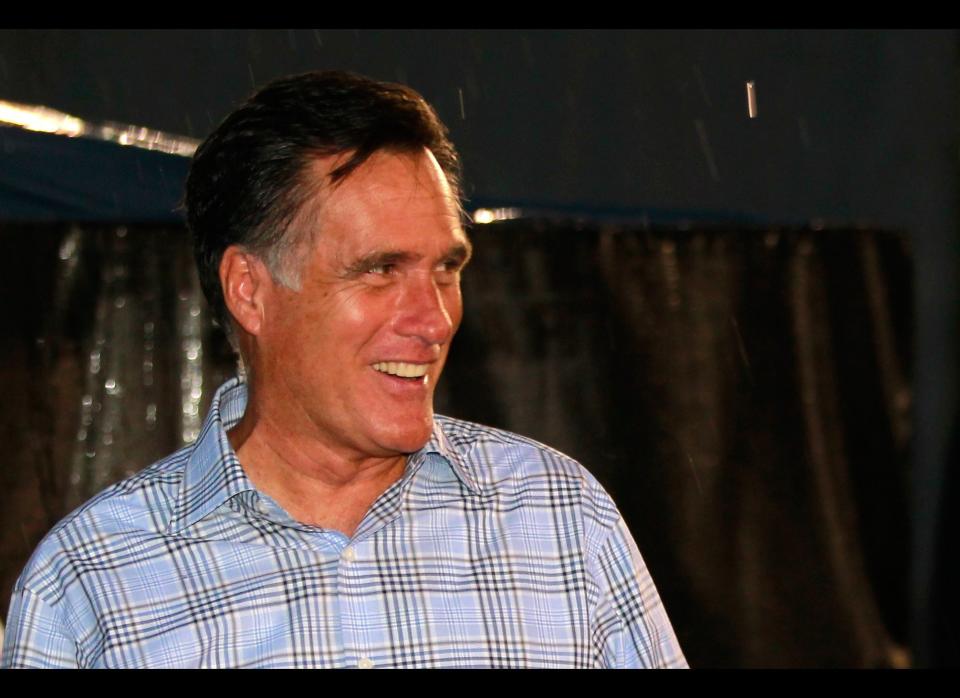 RICHMOND, VA - SEPTEMBER 08:  Republican presidential candidate, former Massachusetts Gov. Mitt Romney smiles as he walks through the garage area during a rain delay before the start of the NASCAR Sprint Cup Series Federated Auto Parts 400 at Richmond International Raceway on September 8, 2012 in Richmond, Virginia.  (Photo by Geoff Burke/Getty Images)