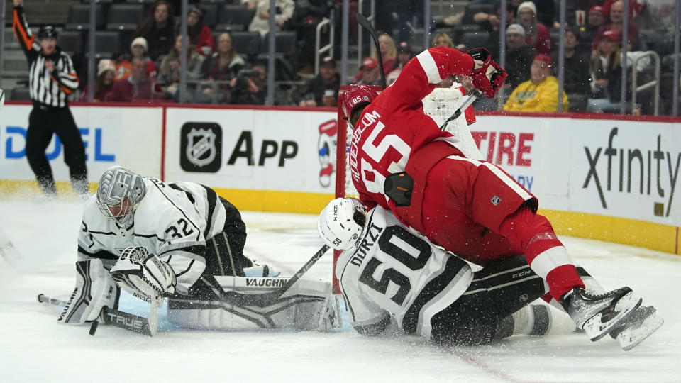 Los Angeles Kings goaltender Jonathan Quick (32) stops the puck while defenseman Sean Durzi (50) takes Detroit Red Wings left wing Elmer Soderblom (85) off his skates in the second period of an NHL hockey game Monday, Oct. 17, 2022, in Detroit. (AP Photo/Paul Sancya)