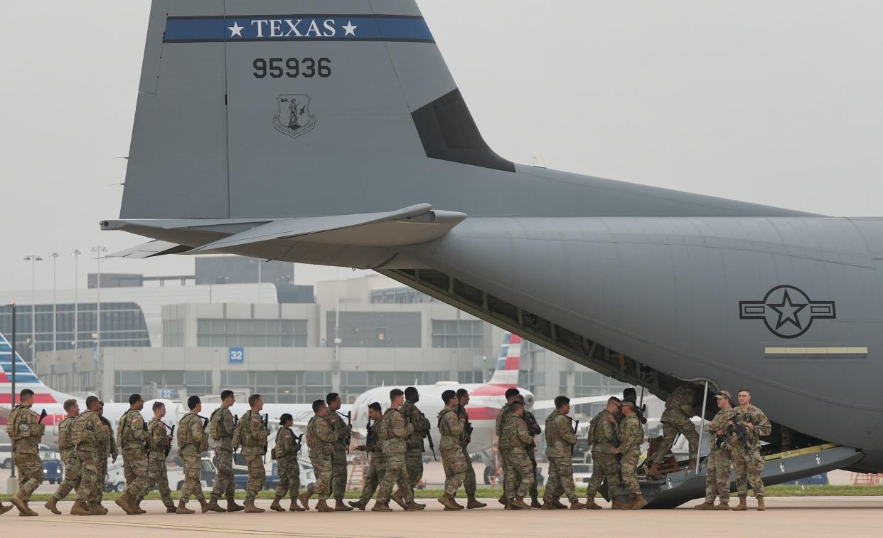 Troops activated for Operation Lone Star board a Texas Air National Guard cargo plane from Austin-Bergstrom International Airport last May.