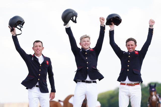 Scott Brash (left), Ben Maher (right) and Harry Charles celebrate winning gold