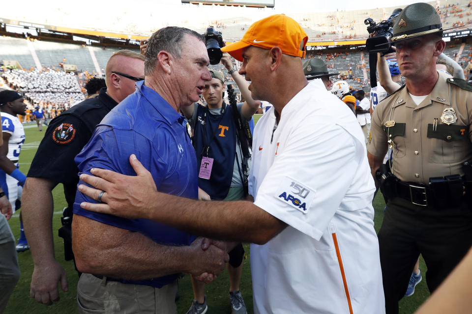 Georgia State head coach Shawn Elliott, left, is congratulated by Tennessee head coach Jeremy Pruitt after a win an NCAA college football game Saturday, Aug. 31, 2019, in Knoxville, Tenn. (AP Photo/Wade Payne)