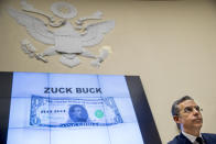 Facebook CEO Mark Zuckerberg's face is visible on a mock "Zuck Buck" depicted on a screen behind David Marcus, CEO of Facebook's Calibra digital wallet service, as he is questioned by Rep. Brad Sherman, D-Calif., during a House Financial Services Committee hearing on Facebook's proposed cryptocurrency on Capitol Hill in Washington, Wednesday, July 17, 2019. (AP Photo/Andrew Harnik)
