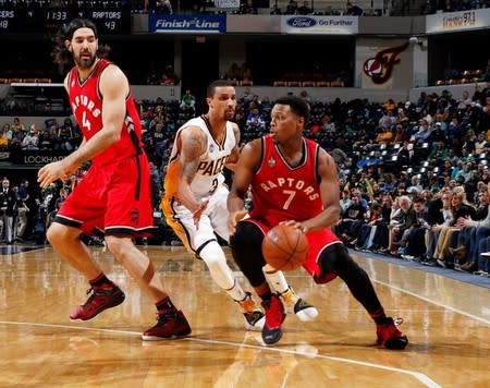 Toronto Raptors guard Kyle Lowry (7) drives to the basket against Indiana Pacers guard George Hill (3) at Bankers Life Fieldhouse. Toronto defeats Indiana 101-94 in overtime. Mandatory Credit: Brian Spurlock-USA TODAY Sports