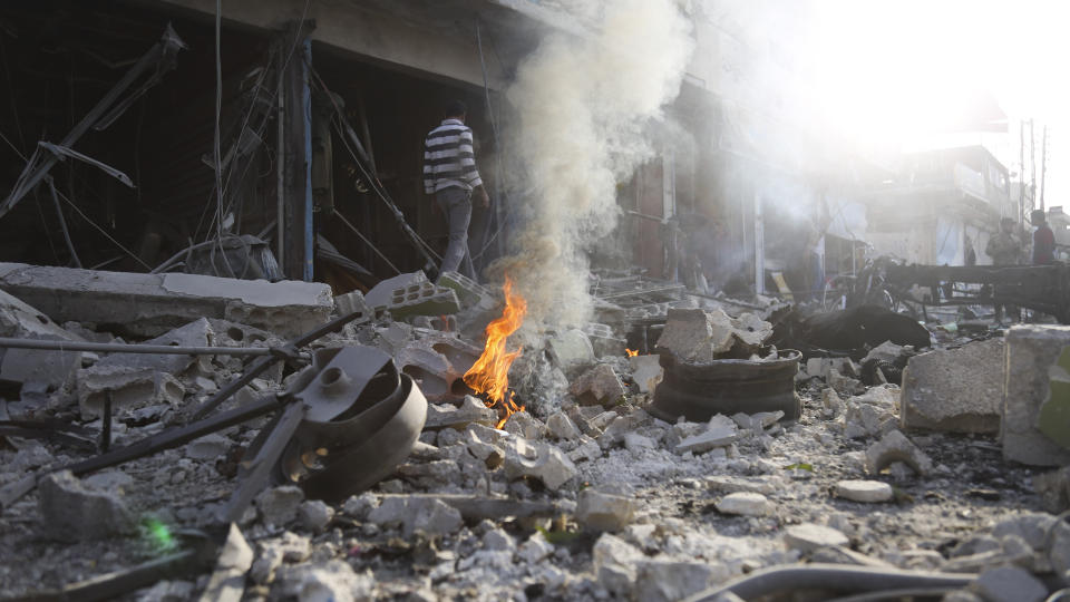 People check the destruction after a car bomb exploded in Tal Abyad, Syria, Friday, Nov. 2, 2019. A car bomb exploded in a northern Syrian town along the border with Turkey Saturday killing over a dozen of people, Turkey's defense ministry said. (AP Photo)