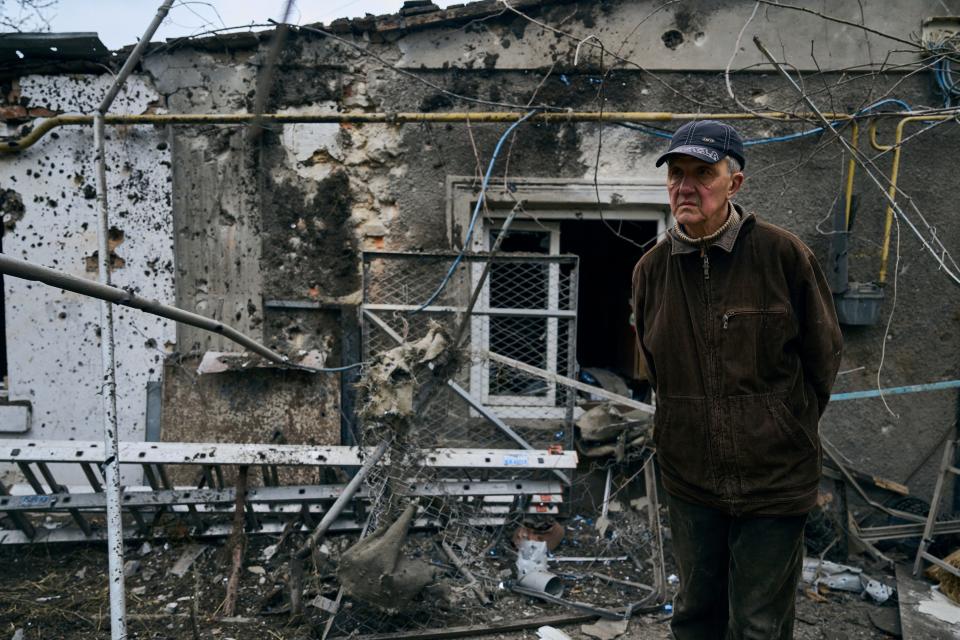 A resident looks at his destroyed house after Russian shelling in Kherson, Ukraine, on Thursday.