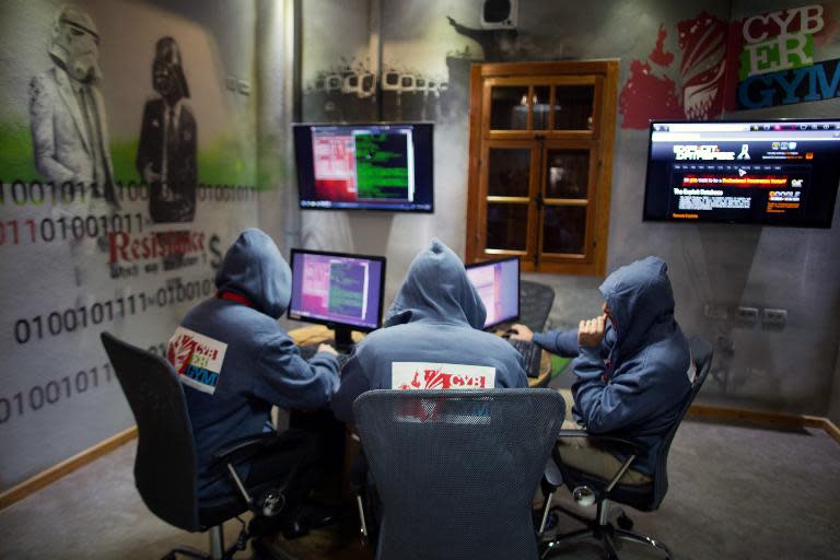 Trainees work at the "Cyber Gym" centre, where IT and infrastructure company employees train to defend against cyber attacks near the Israeli city of Hedera,on October 30, 2013