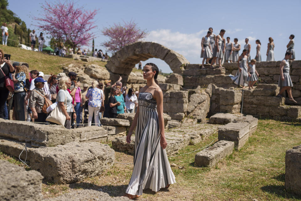 Performers, who will take part in the flame lighting ceremony for the Paris Olympics, leave after a rehearsal at Ancient Olympia site, Greece, Sunday, April 14, 2024. Every two years, a countdown to the Olympic games is launched from its ancient birthplace with a flame lighting ceremony in southern Greece at Ancient Olympia. The event is marked with a performance by dancers who assume the role of priestesses and male companions, their movement inspired by scenes on millennia-old artwork. (AP Photo/Petros Giannakouris)
