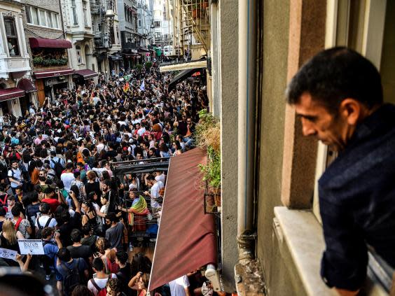 A man looks on as LGBT+ rights activists take part in a march (AFP/Getty)