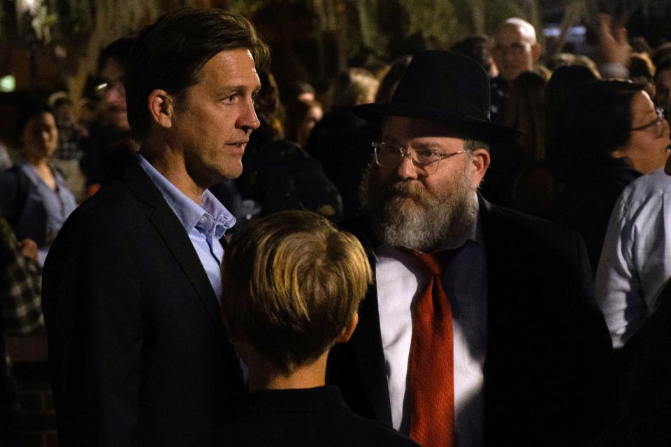 UF President Ben Sasse, left, attends a candlelight vigil for the conflict in the Middle East in the University of Florida’s Turlington Plaza Monday night, Oct. 9, 2023.