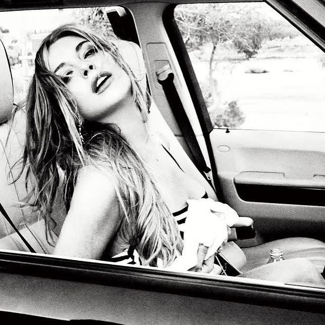 Lindsay Lohan poses inside a car