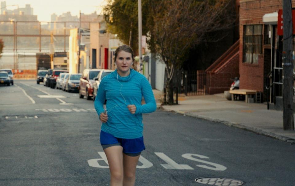 Jillian Bell runs down the street