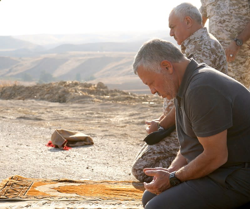 Jordan's King Abdullah prays as he take part in a ceremony, in an area known as Naharayim in Hebrew and Baquora in Arabic