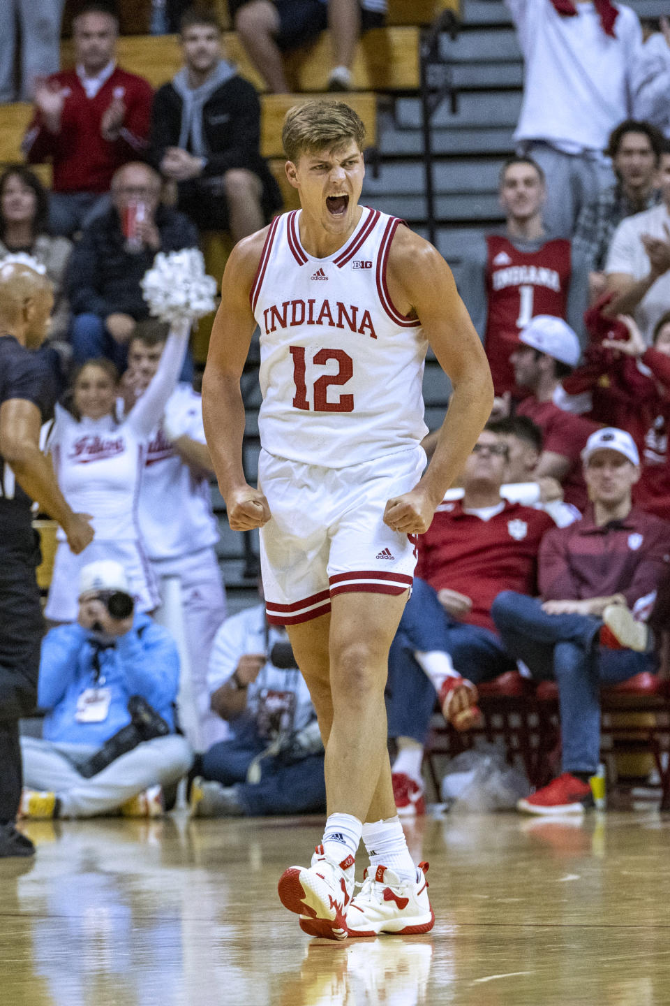 Indiana forward Miller Kopp (12) reacts after scoring a 3-point basket during the second half of the team's NCAA college basketball game against Morehead State, Monday, Nov. 7, 2022, in Bloomington, Ind. (AP Photo/Doug McSchooler)