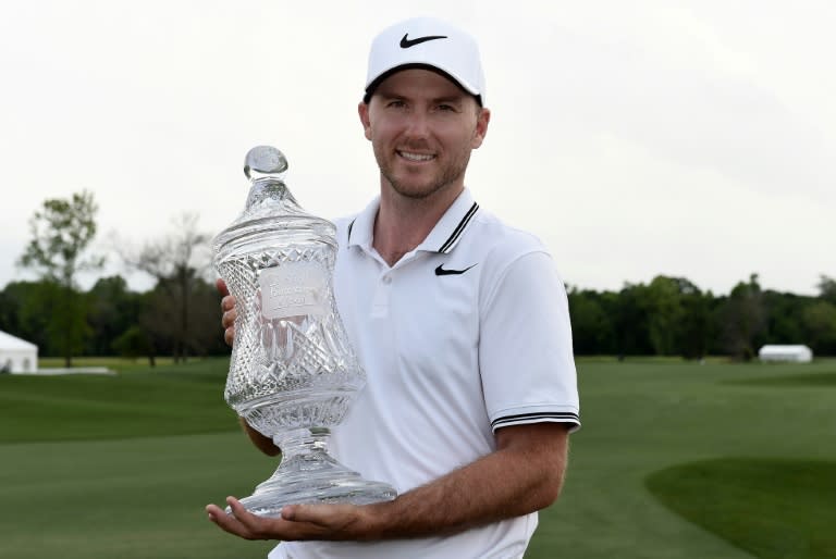 Russell Henley of the US poses with the trophy on the 18th green after winning the Shell Houston Open, in Humble, Texas, on April 2, 2017