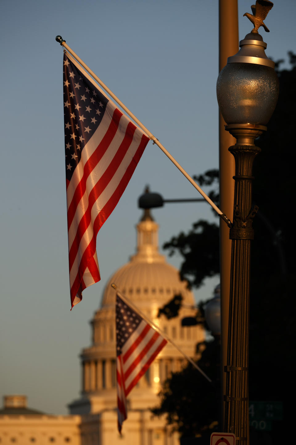 Flags fly at sunset with 51 instead of the usual 50 stars, along Pennsylvania Ave., part of a display in support of statehood for the District of Columbia, Sunday, Sept. 15, 2019, in Washington. (AP Photo/Jacquelyn Martin)