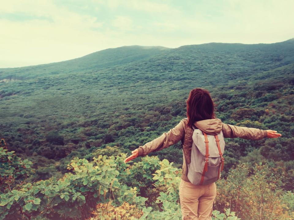 woman backpacking travel alone mountains hiking