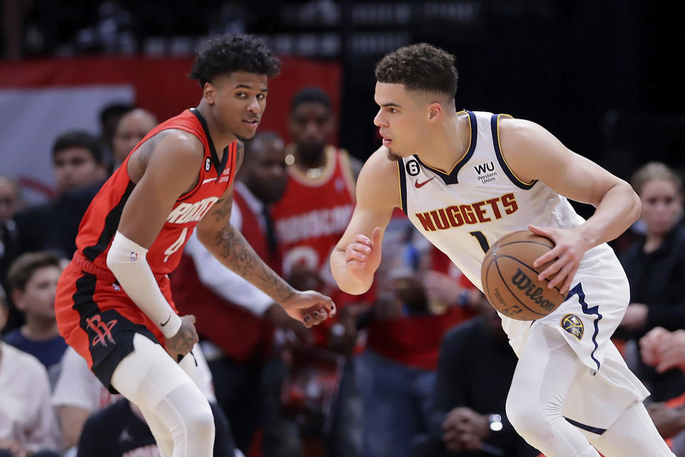 Denver Nuggets forward Michael Porter Jr., right, drives past Houston Rockets guard Jalen Green, left, during the second half of an NBA basketball game Tuesday, April 4, 2023, in Houston. (AP Photo/Michael Wyke)