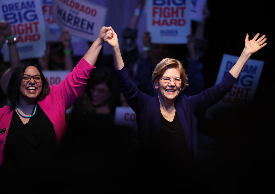 Democratic presidential candidate Sen. Elizabeth Warren, D-Mass., right, acknowledges the crowd with Colorado State Sen. Julie Gonzalez, D-Denver, before speaking at a campaign rally Sunday, Feb. 23, 2020, in Denver. (AP Photo/David Zalubowski)