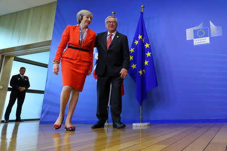 British Prime Minister Theresa May (L) is welcomed by European Commission President Jean-Claude Juncker at the EC headquarters in Brussels, Belgium October 21, 2016. REUTERS/Yves Herman