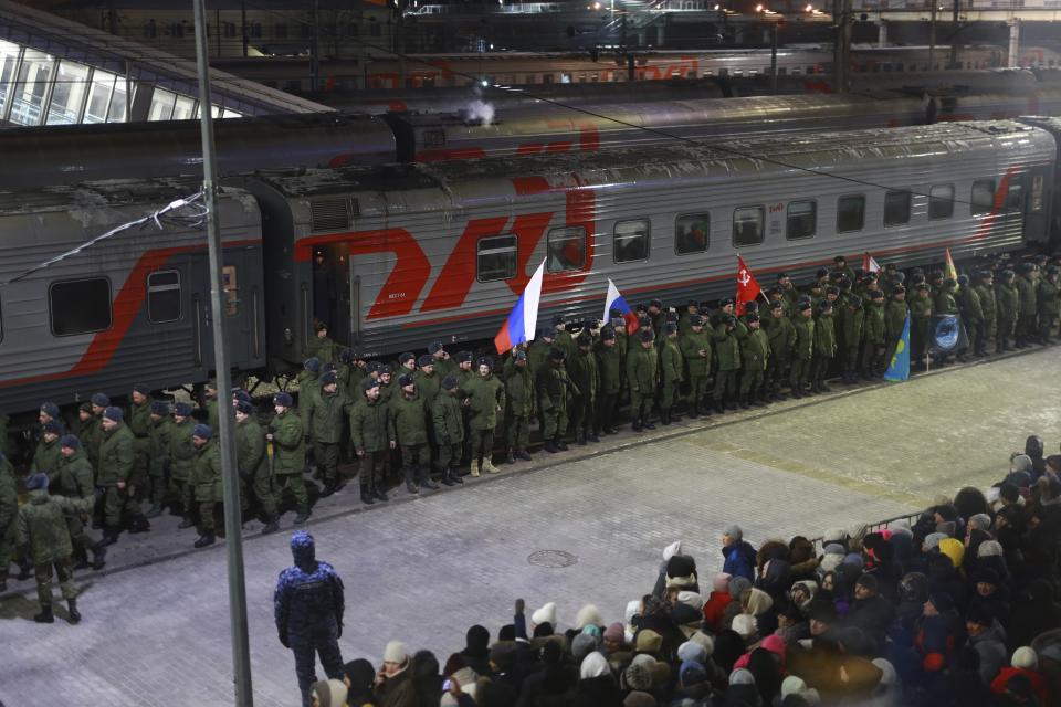 Soldiers who were recently mobilized by Russia for the military operation in Ukraine stand at a ceremony before boarding a train at a railway station in Tyumen, Russia, Friday, Dec. 2, 2022. Russian President Vladimir Putin's order to mobilize reservists for the conflict prompted large numbers of Russians to leave the country. (AP Photo)