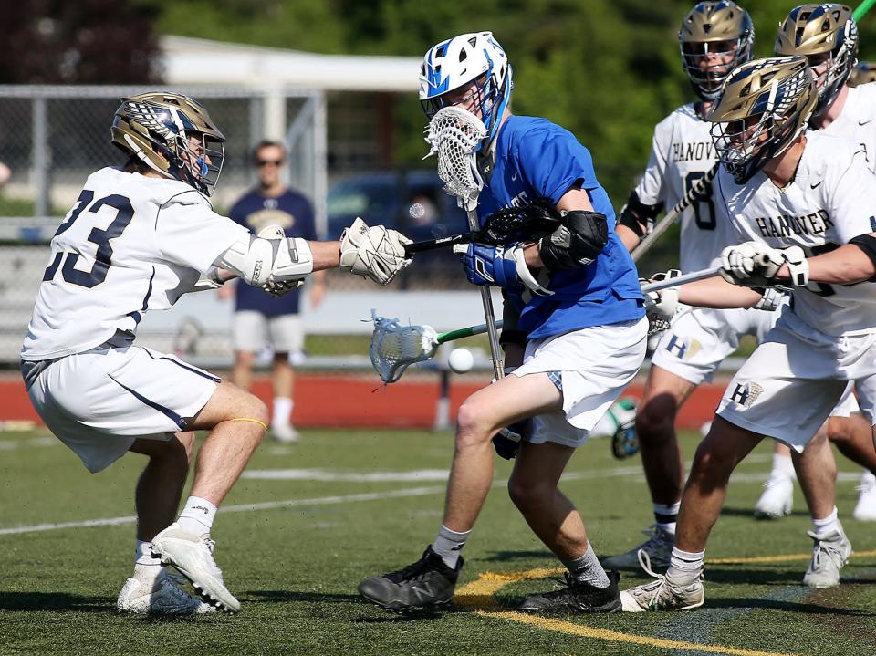 Hanover’s Sean Coughlin looks to prevent Scituate’s Jim Sullivan from getting the ball during first quarter action of  their game at Hanover High on Thursday, May 20, 2021.