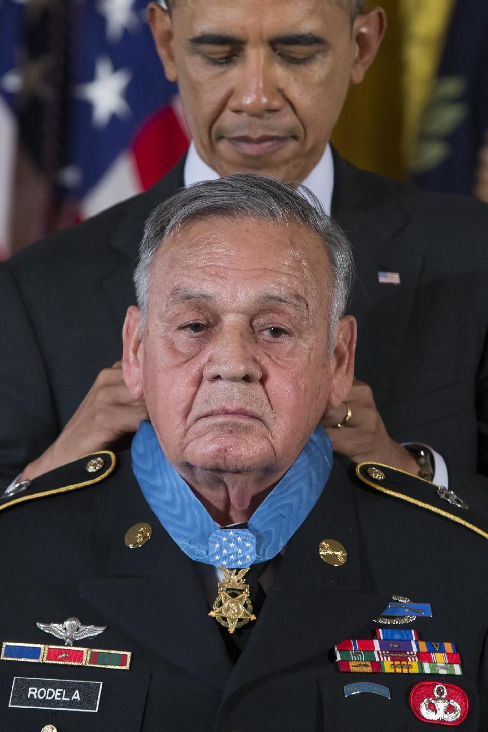 Sgt. 1st Class Jose Rodela is awarded the Medal of Honor by President Barack Obama during a ceremony in the East Room of the White House in Washington, Tuesday, March 18, 2014. President Obama awarded 24 Army veterans the Medal of Honor for conspicuous gallantry in recognition of their valor during major combat operations in World War II, the Korean War and the Vietnam War. (AP Photo/ Evan Vucci)