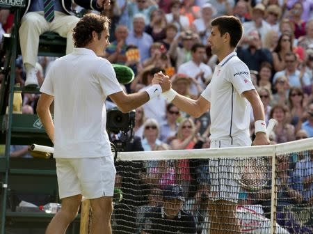 Jul 6, 2014; London, United Kingdom; Roger Federer (SUI) and Novak Djokovic (SRB) meet at the net after the men's final match on day 13 of the 2014 Wimbledon Championships at the All England Lawn and Tennis Club. Susan Mullane-USA TODAY Sports