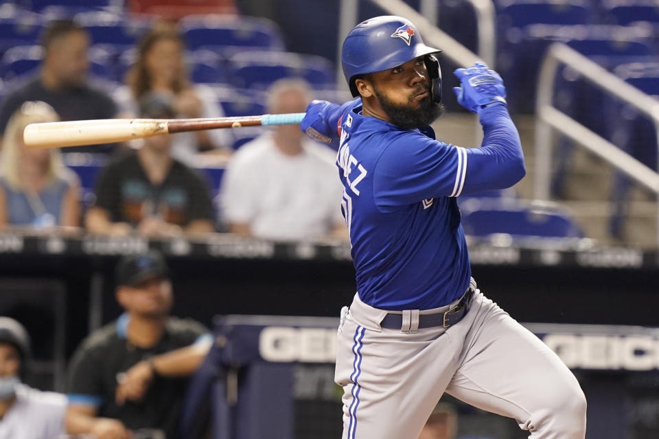 Toronto Blue Jays' Teoscar Hernandez hits a double during the first inning of a baseball game against the Miami Marlins, Wednesday, June 23, 2021, in Miami. The hit allowed the first run of the game. (AP Photo/Marta Lavandier)