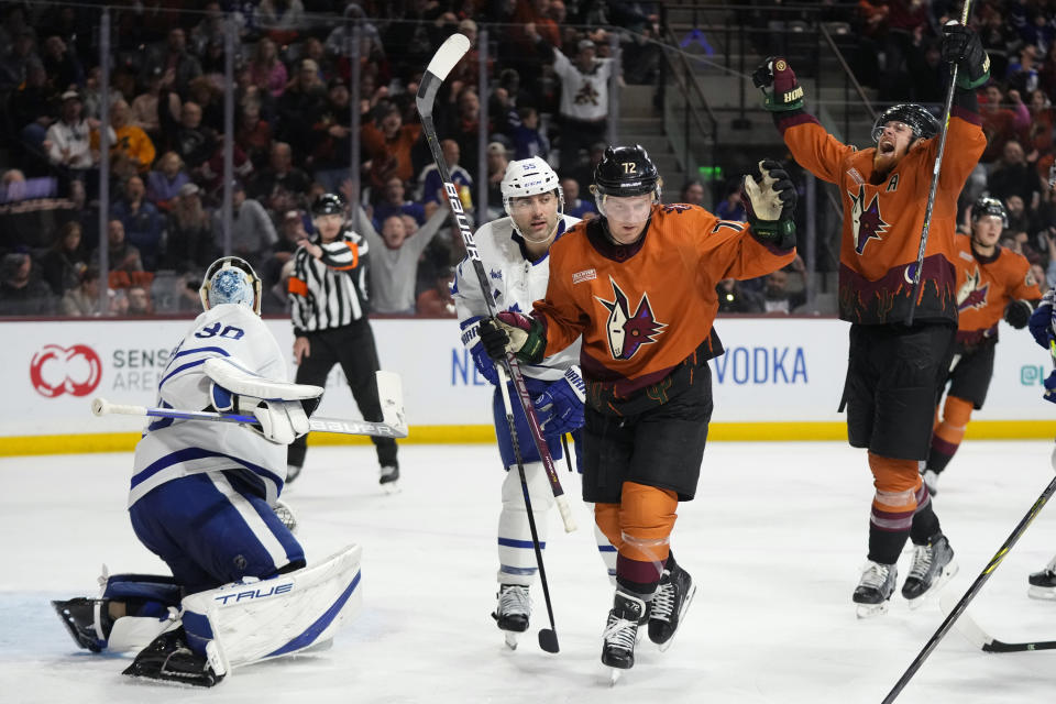 Arizona Coyotes center Travis Boyd (72) and left wing Lawson Crouse, right, celebrate a goal by J.J. Moser against Toronto Maple Leafs goaltender Matt Murray (30), while Maple Leafs defenseman Mark Giordano (55) looks on during the third period of an NHL hockey game in Tempe, Ariz., Thursday, Dec. 29, 2022. The Coyotes won 6-3. (AP Photo/Ross D. Franklin)