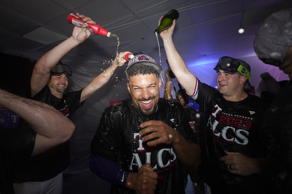 Texas Rangers' Marcus Semien celebrates with teammates after winning an American League Division Series baseball game against the Baltimore Orioles in Arlington, Texas, Tuesday, Oct. 10, 2023. (AP Photo/Julio Cortez)