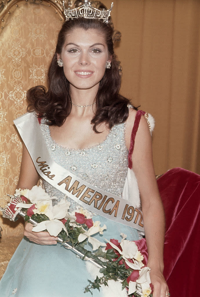 Schaefer holding flowers and wearing a crown