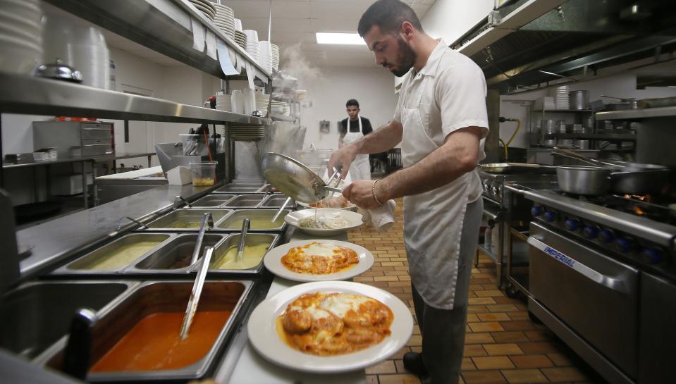 Pasta Al Forno Italian restaurant co-owner and chef Aron Dreshaj prepares meals for customers in the restaurant's kitchen, Friday, May 19, 2023, on 13th Street, in Ames, Iowa.