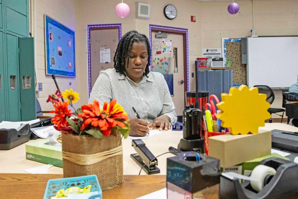 Paraprofessional Tameka Mays works at her desk during a session of class N-1 at George Read Middle School in New Castle, Tuesday, Feb. 20, 2024.